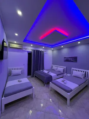 a room with two beds and a purple ceiling at Keno & Keon in Ulcinj