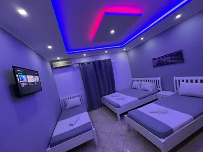 a room with two beds and a tv in it at Keno & Keon in Ulcinj