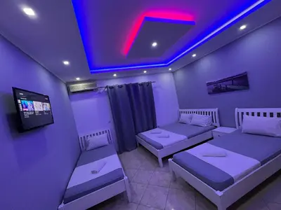 a room with two beds and a tv in it at Keno & Keon in Ulcinj