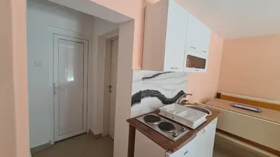 a kitchen with a sink and a stove in it at Apartments Bulatović in Bar