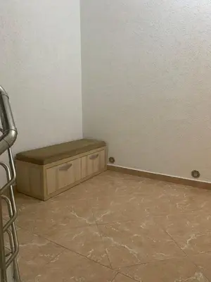 a room with a bench in the corner of a room at Duraku Apartment in Ulcinj