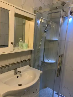 a bathroom with a sink and a shower at Duraku Apartment in Ulcinj