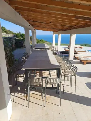 a table and chairs on a patio with the ocean at Villa Harizma in Budva