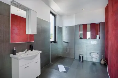 a bathroom with a white sink and a toilet at Villa Harizma in Budva