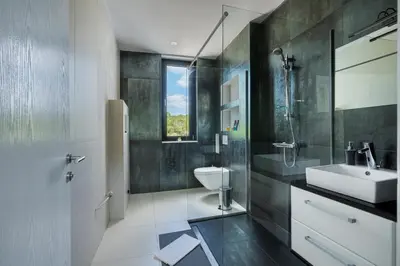 a bathroom with a sink and a toilet at Villa Harizma in Budva
