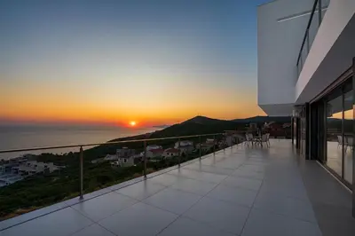 a view of the sunset from the balcony of a building at Villa Harizma in Budva