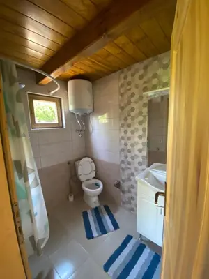 a small bathroom with a toilet and a sink at Peaceful Oasis in Ulcinj
