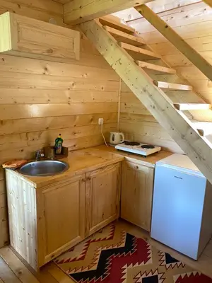a kitchen with a sink in a log cabin at Peaceful Oasis in Ulcinj