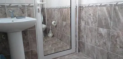 a bathroom with a shower and a sink at Apartmani Jacimovic in Čanj