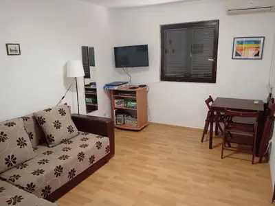 a living room with a couch and a table at Vesela vila in Sutomore