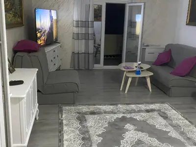 a living room with a couch and a table at Apartman Lara in Sveti Stefan