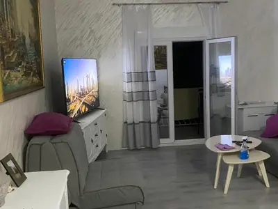 a living room with a couch and a tv at Apartman Lara in Sveti Stefan