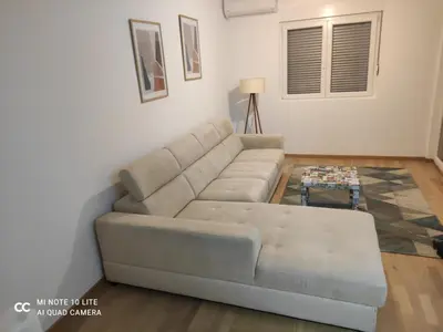 a living room with a couch and a table at Podgorica apartman in Podgorica