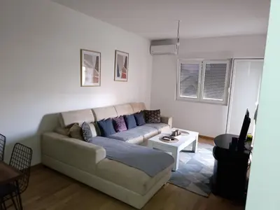 a living room with a couch and a table at Podgorica apartman in Podgorica