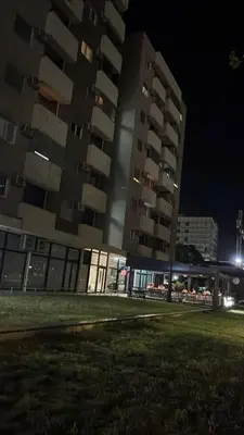 two tall buildings in a city at night at Podgorica apartman in Podgorica