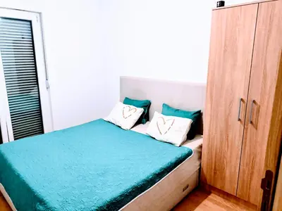 a bedroom with a bed with two pillows on it at Podgorica apartman in Podgorica
