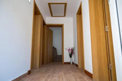 a hallway with a vase of flowers in a room at Gazdinstvo Popovic,Kucka Korita-Podgorica in Podgorica