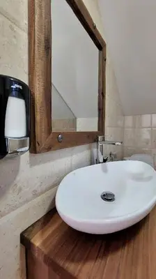 a bathroom with a white sink and a mirror at Gazdinstvo Popovic,Kucka Korita-Podgorica in Podgorica