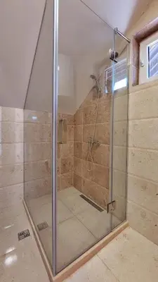 a shower with a glass door in a bathroom at Gazdinstvo Popovic,Kucka Korita-Podgorica in Podgorica