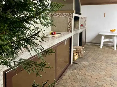 a kitchen with a stove and a christmas tree at 3 Bedroom Apartment with pool in Čeluga
