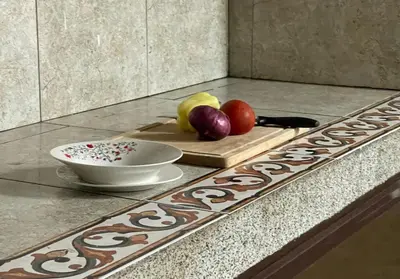 a bowl of fruit on a cutting board on a counter at 3 Bedroom Apartment with pool in Čeluga