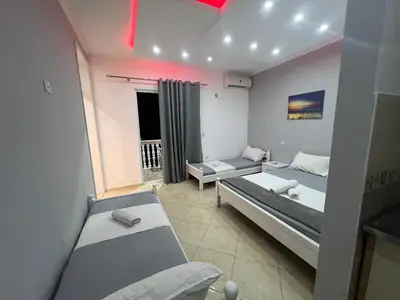 a small room with two beds and a couch at K&K Apartments 1 in Ulcinj