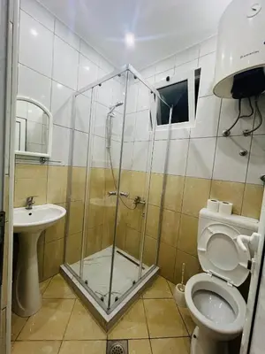 a bathroom with a shower and a toilet and a sink at K&K Apartments 1 in Ulcinj