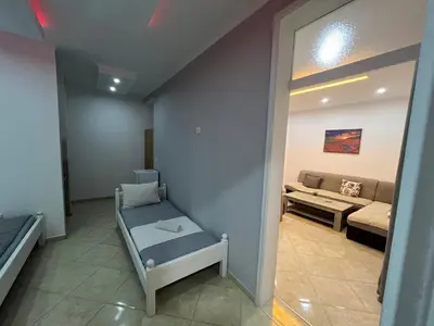 a living room with a couch and a bench at K&K Apartments 1 in Ulcinj