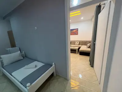 a small room with a bed and a couch at K&K Apartments 1 in Ulcinj