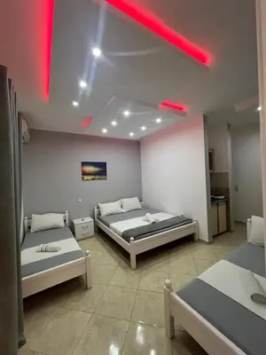 a room with two beds and a red light at K&K Apartments 1 in Ulcinj