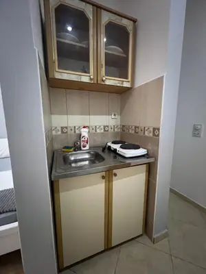 a small kitchen with a sink and cabinets at K&K Apartments 1 in Ulcinj