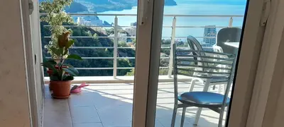 a view of a balcony with a chair and a table at Apartmani Ličina in Becici