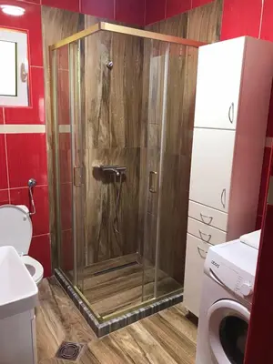 a shower with a glass door in a bathroom at Apartmani Ličina in Becici