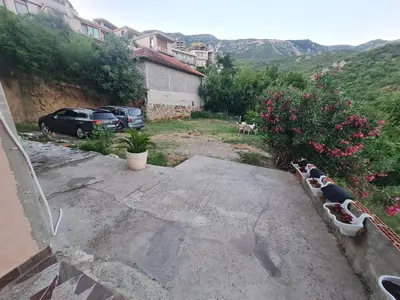 a view of a parking lot with cars and flowers at Apartmani Ličina in Becici