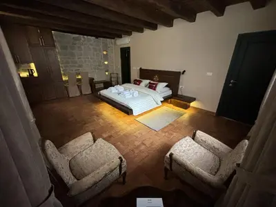an overhead view of a bedroom with a bed and two chairs at KAŽIN supreme in Kotor