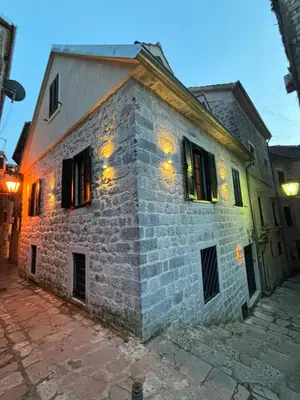 an old stone building with lights on it at KAŽIN supreme in Kotor