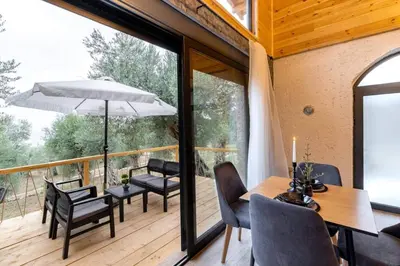 a room with a balcony with a table and chairs at Olive Treasure in Ulcinj