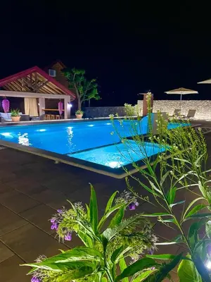 a swimming pool in a resort at night at Cosy Cottage with Private Pool - Andrej in Danilovgrad
