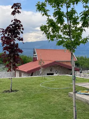 a building with a red roof and a basketball hoop at Cosy Cottage with Private Pool - Andrej in Danilovgrad
