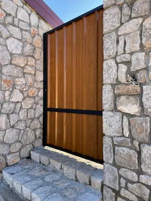 a wooden door on the side of a stone wall at Cosy Cottage with Private Pool - Andrej in Danilovgrad