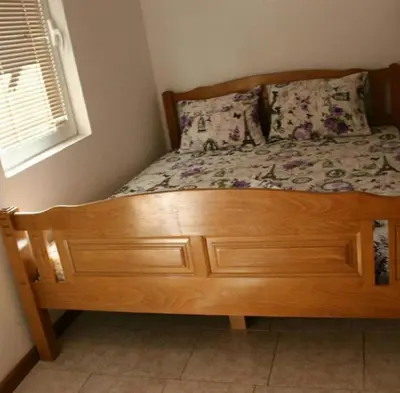 a wooden bed with a wooden dresser in a bedroom at Bojana Blue Retreat in Ulcinj