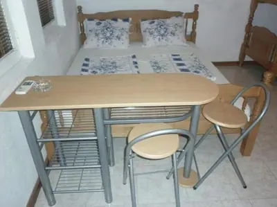 a table with two chairs and a bed in a room at Bojana Blue Retreat in Ulcinj