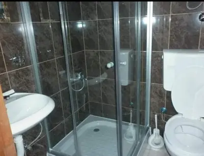 a bathroom with a shower with a toilet and a sink at Bojana Blue Retreat in Ulcinj