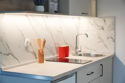 a kitchen counter top with a sink and a counter top at Mar nero Apartments in Bregvija