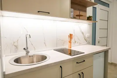 a kitchen with a sink and a counter top at Mar nero Apartments in Bregvija