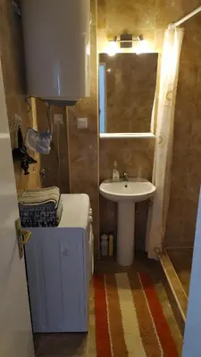a small bathroom with a sink and a toilet and a sink at FLAT FOR RENT MARINOVIC in Budva