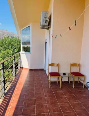 two chairs sitting on the balcony of a house at House of peace in Podgorica