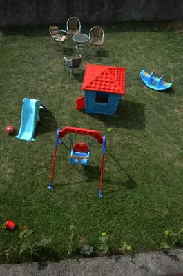 a toy park with a play set in the grass at House of peace in Podgorica