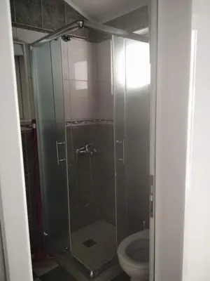 a glass shower in a bathroom with a toilet at Daco22 in Becici