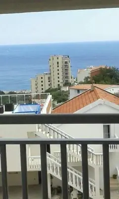 a balcony with a view of the ocean and buildings at Daco22 in Becici
